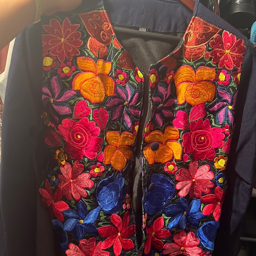 Beautiful blue jacket hand made flowers on the front. Made in Guatemala size L.